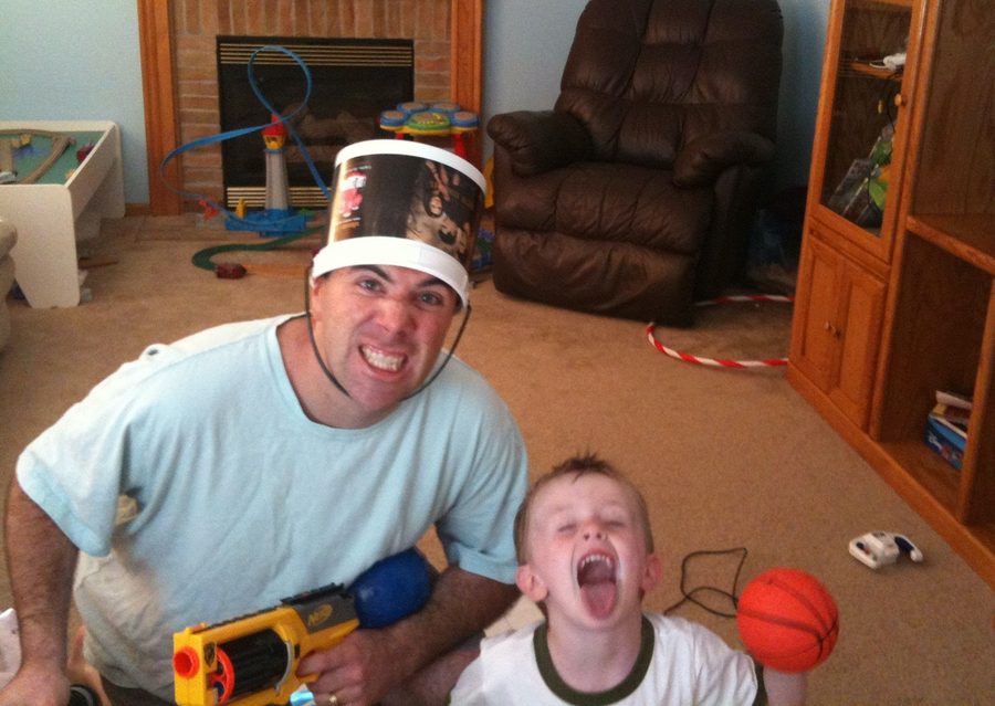 John Nemo wearing a popcorn bucket as a helmet during a Nerf battle with his son